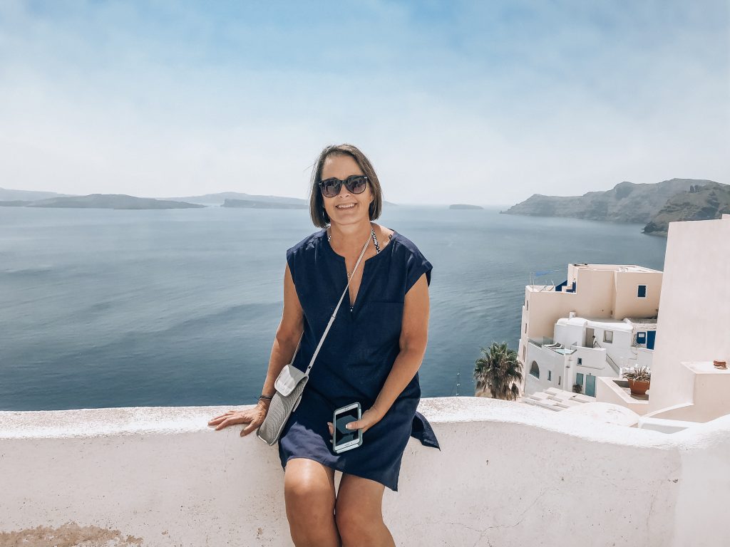sitting on balcony in Santorini