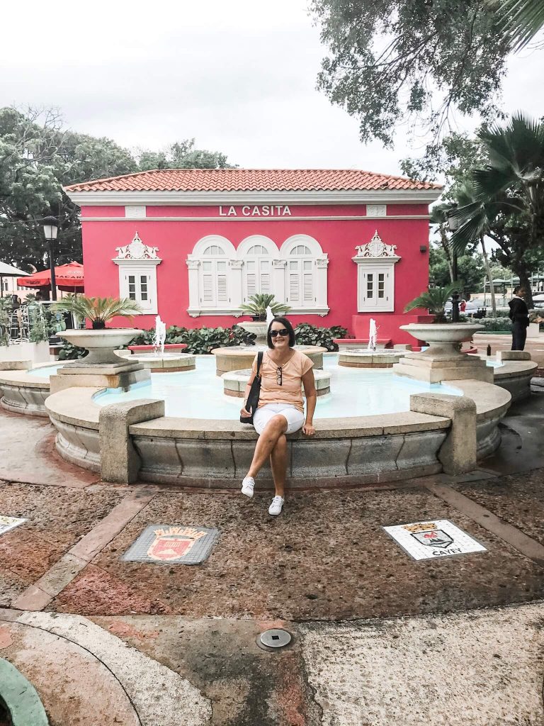Woman sitting in front of fountain