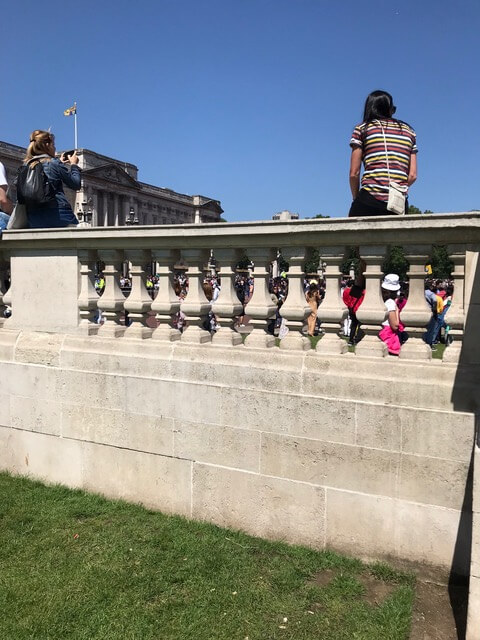 Girl sitting on stone wall