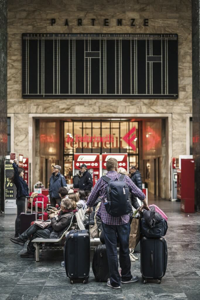 Man with multiple suitcases, backpacks