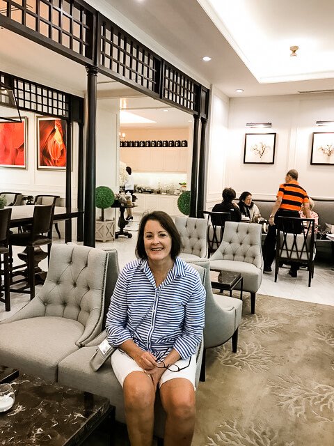 Woman sitting in chair in airport lounge