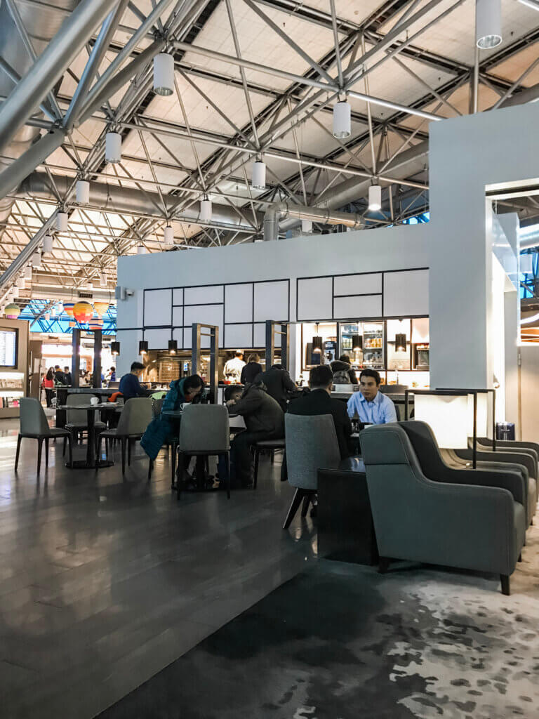 People sitting at tables eating in Taiwan airport