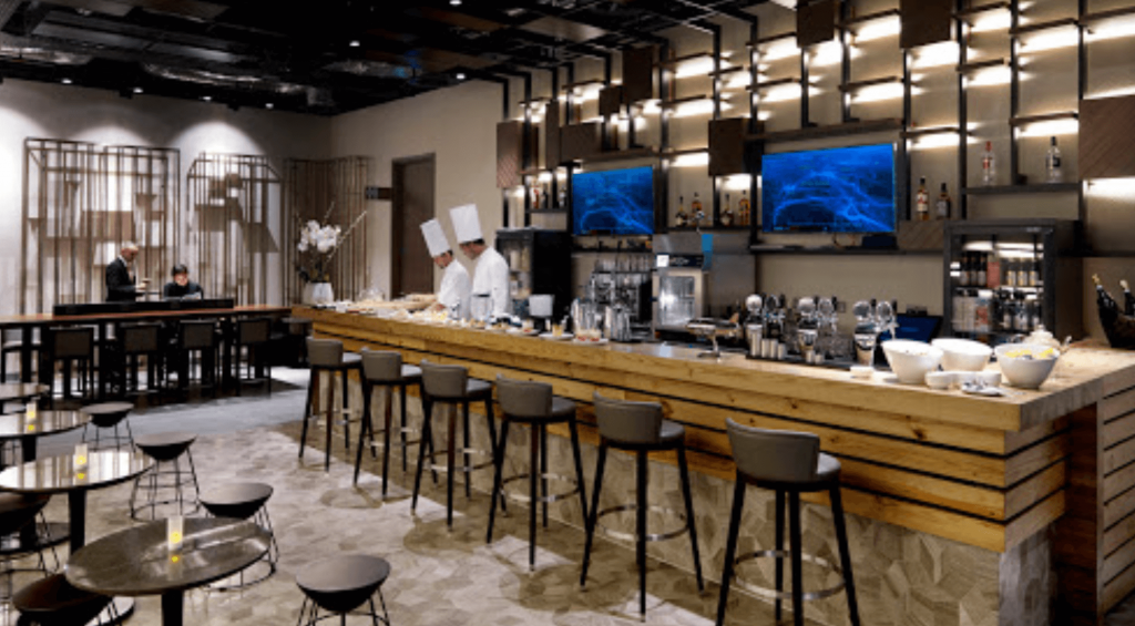 Men in chef hats standing behind bar