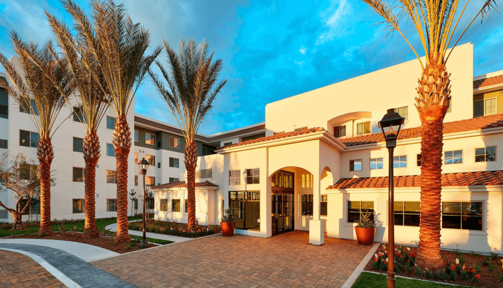 Cream colored hotel with palm trees