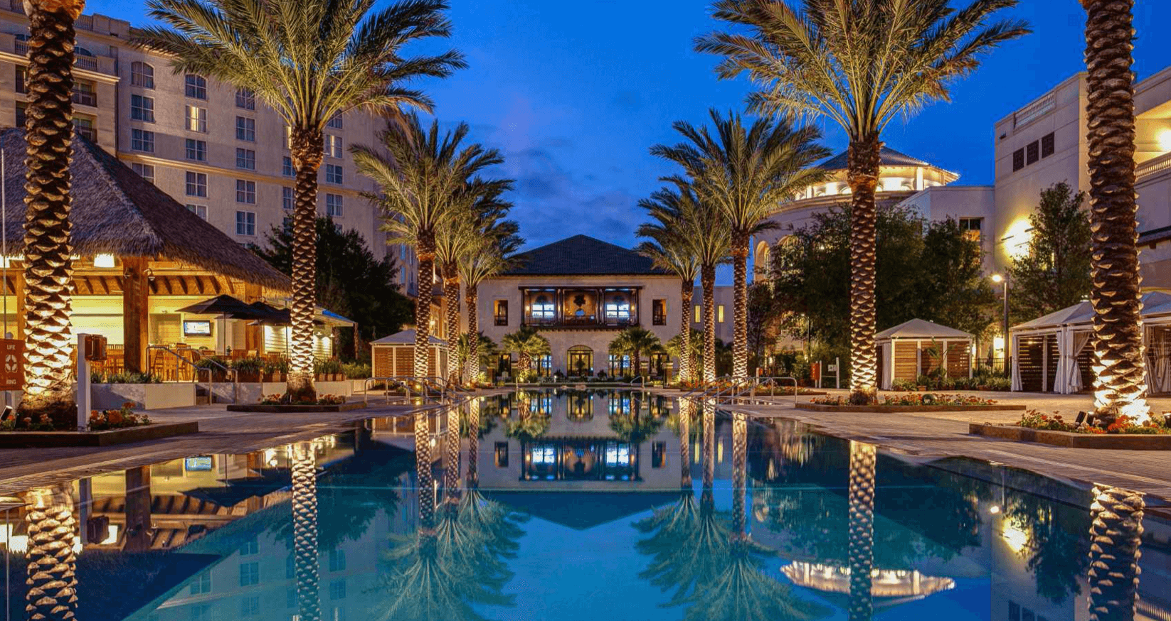 Large Hotel with pool and palm trees