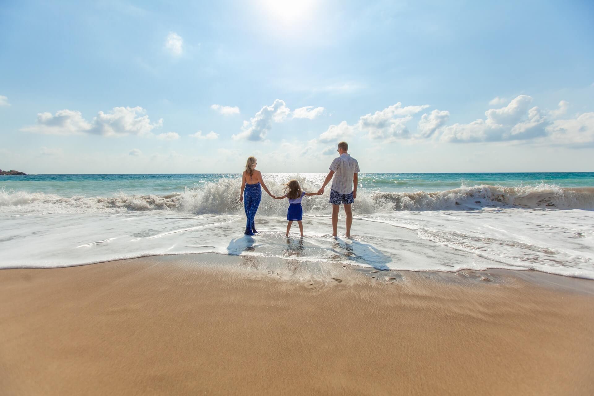 Family holding hands on beach