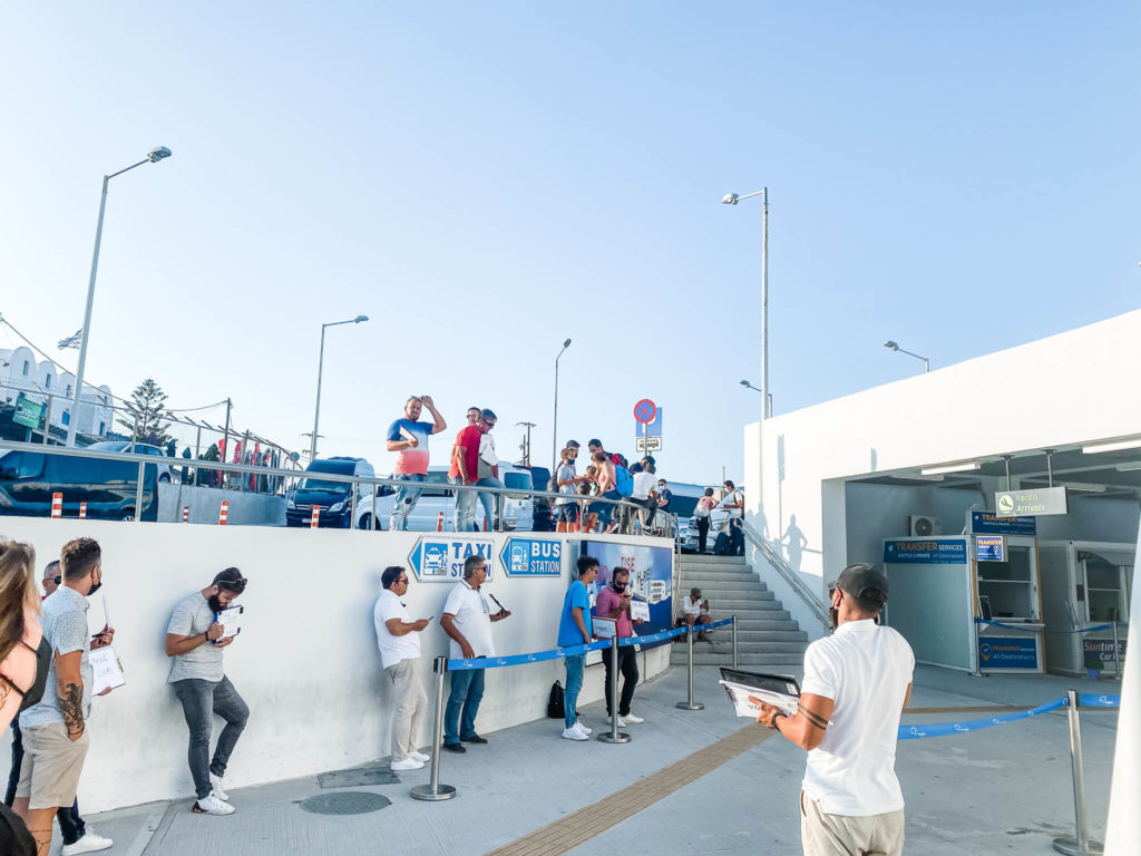 People holding signs outside an airport