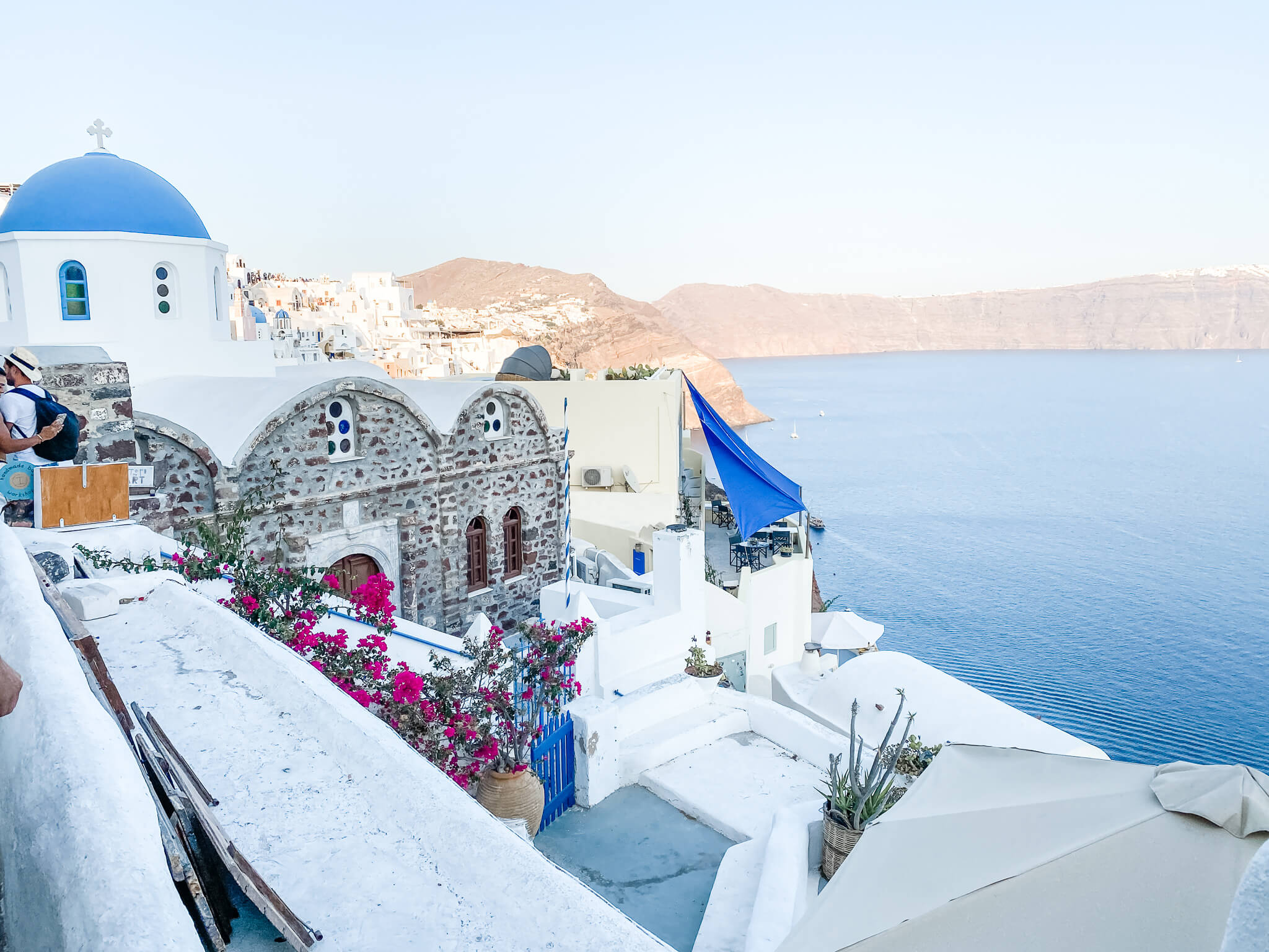 White stacked houses overlooking blue sea