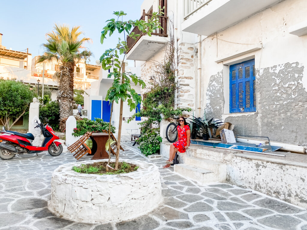 Woman in red dress sitting on ledge