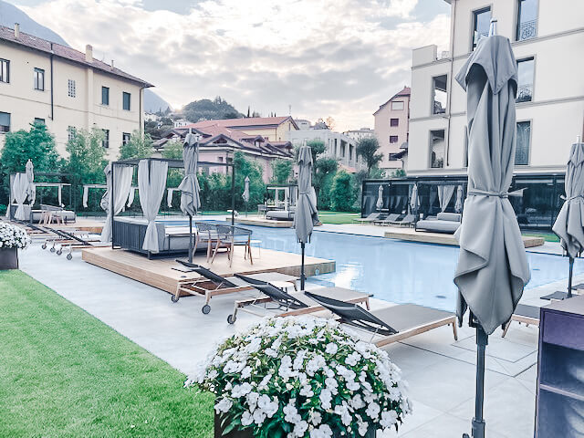 Pool surrounds by loungers and flowers