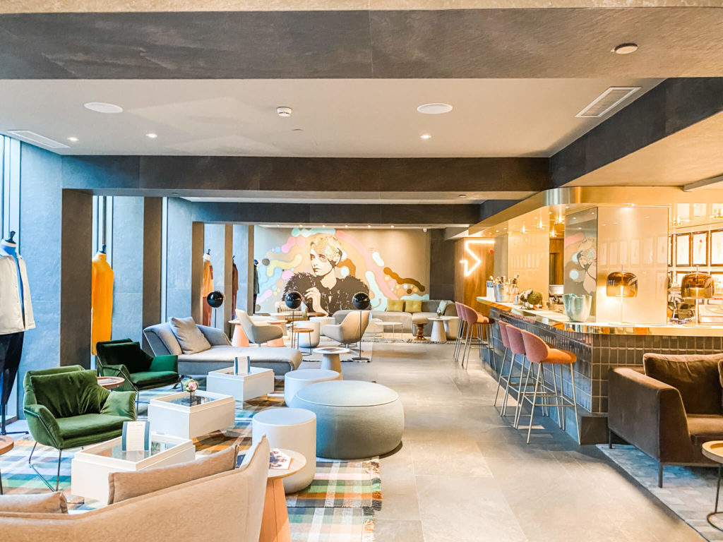 hotel lobby with colorful mural on one wall