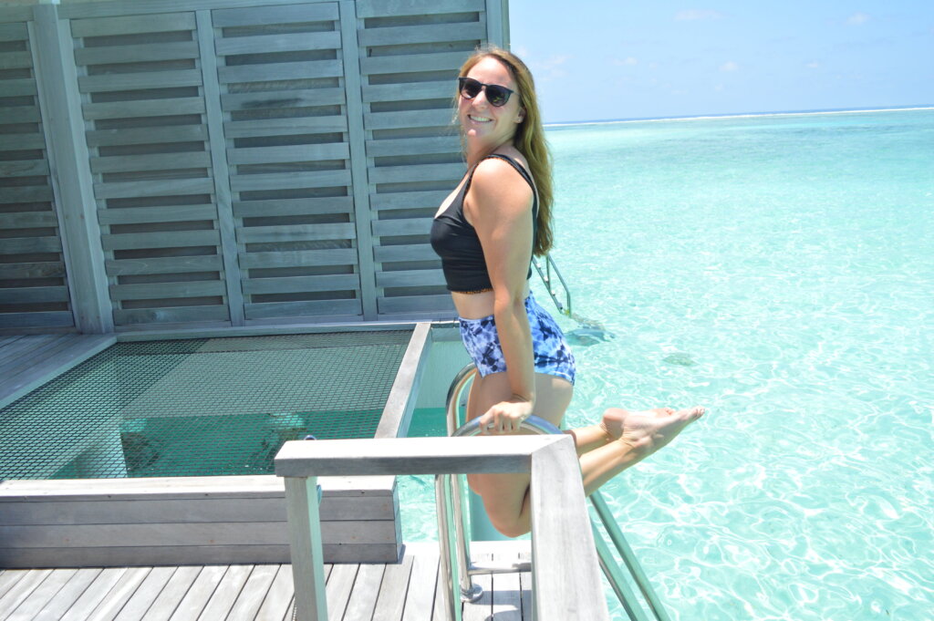 Girl holding self up over water