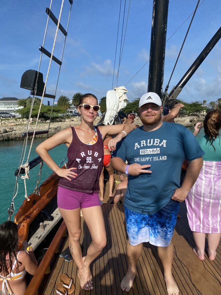 Man and woman standing on deck of sailboat