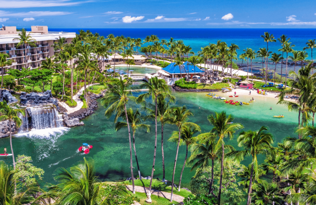 Large resort near palm trees and blue water