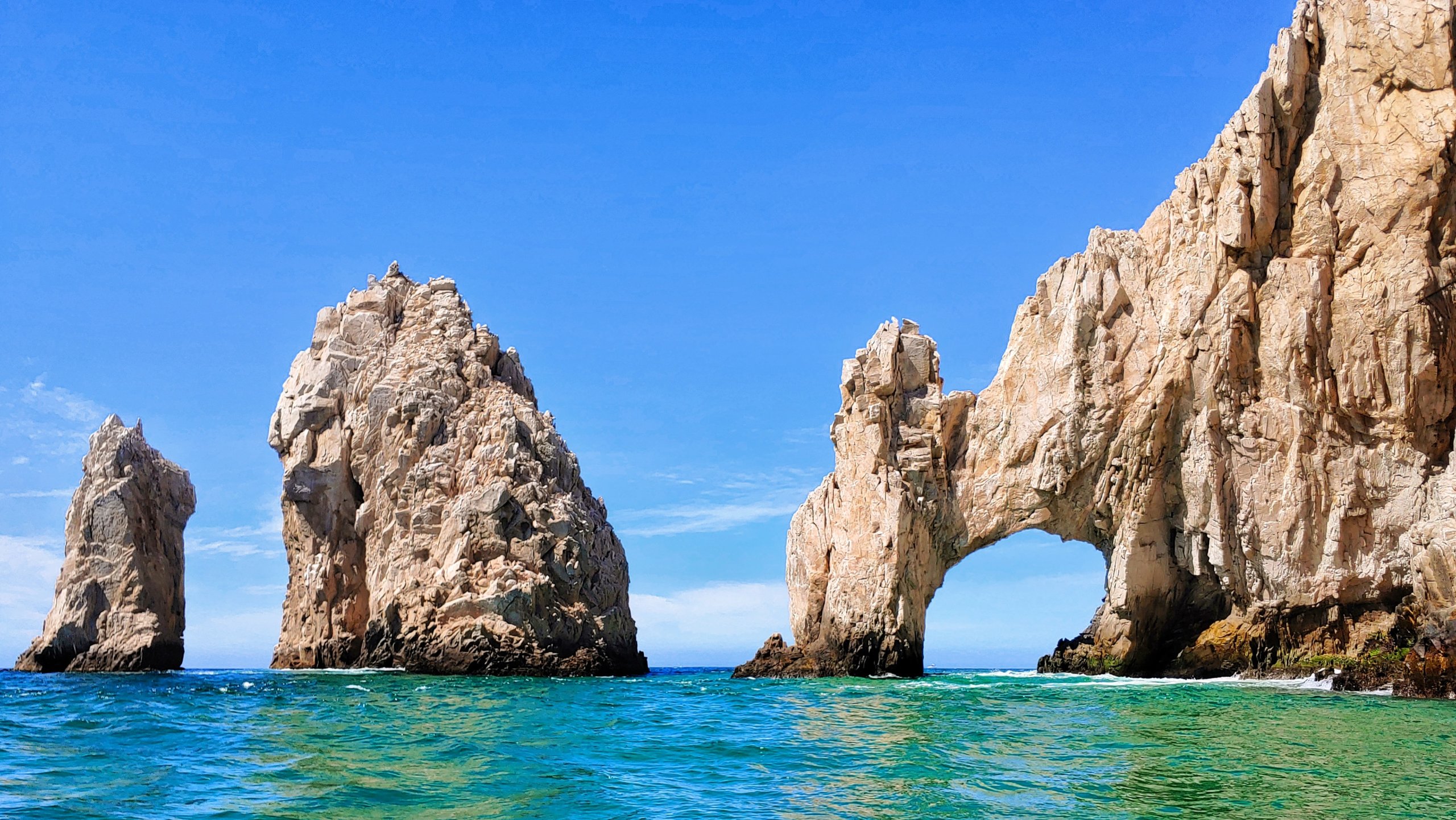 Rock arches in blue water