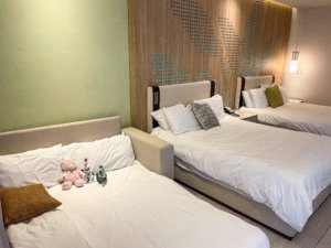 Hotel room with two beds and sofa bed