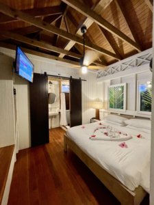 Hotel room with white bed and heart made of flowers