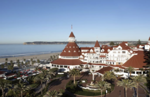 Hotel with red tile roof near blue water