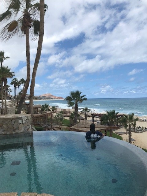 Woman standing at edge of infinity pool