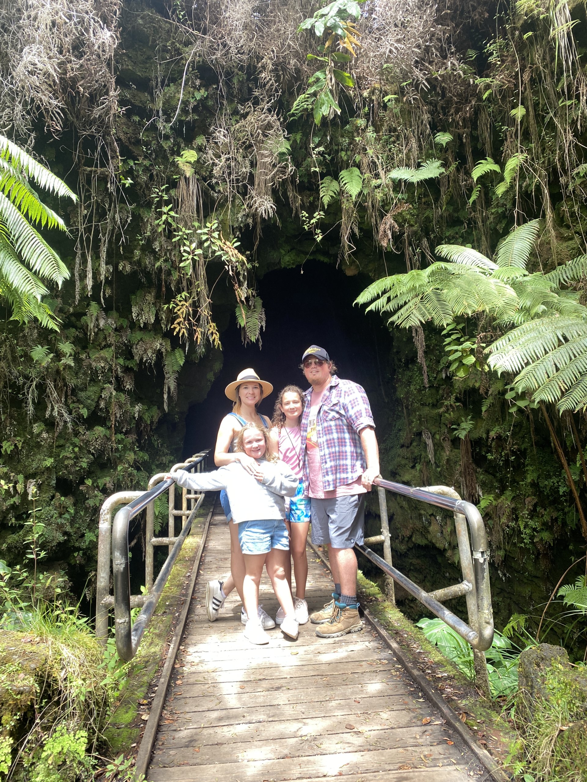 Family standing in front of greenery on path