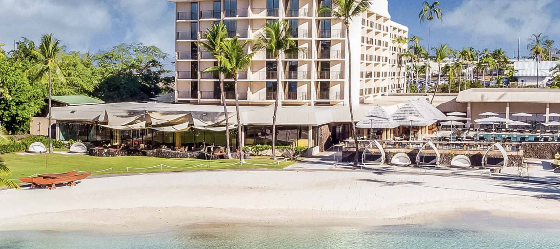 Screenshot of white hotel near beach