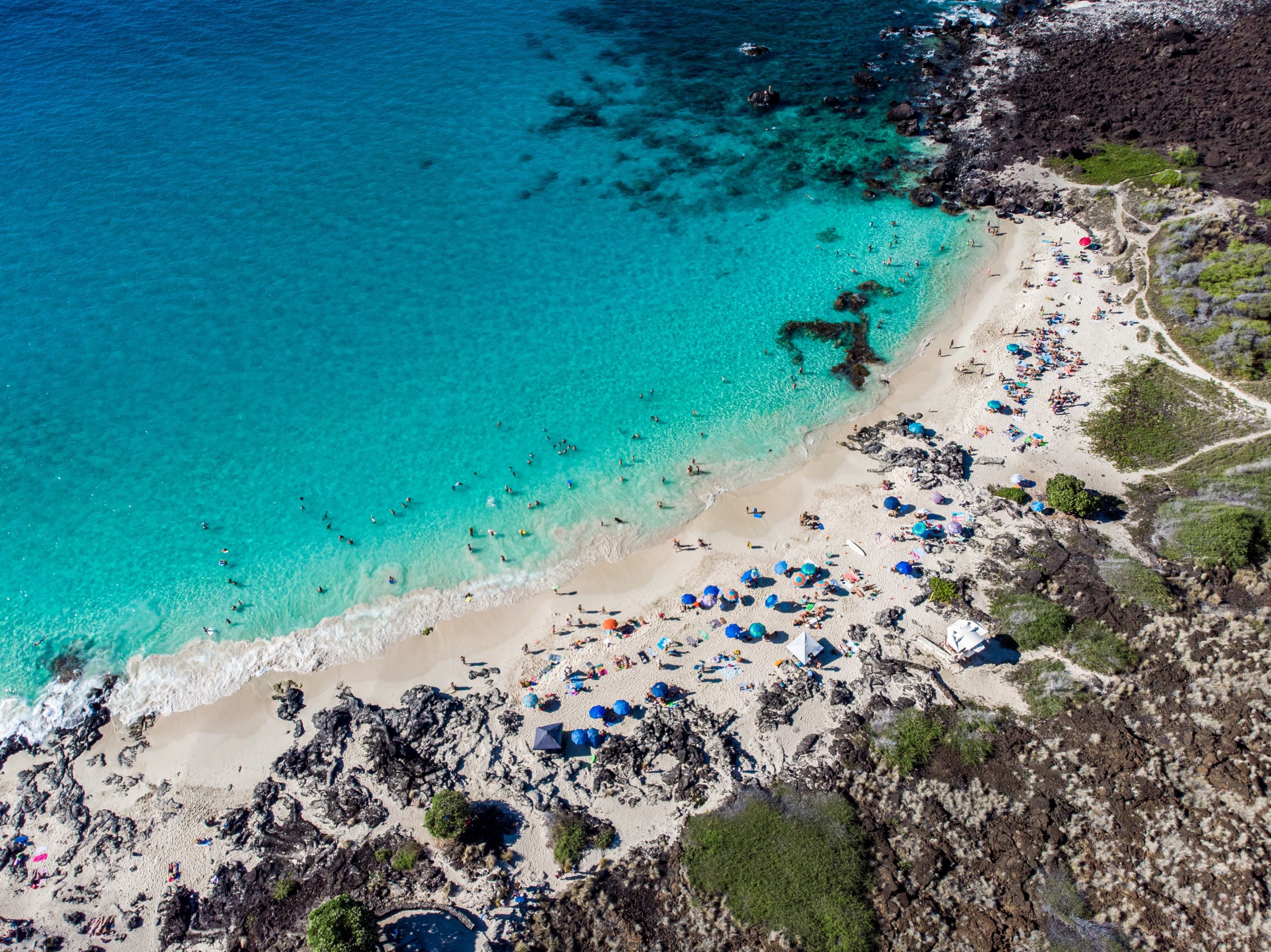 Beach, blue water and lava rocks