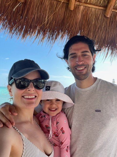 Man, woman, and young daughter smiling