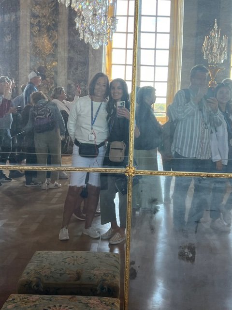 Two women looking in mirror