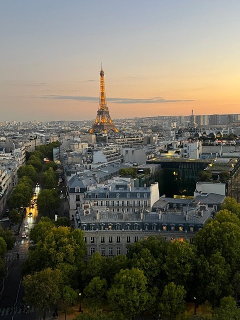 Lit tower among buildings