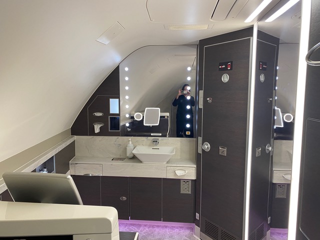 Woman taking picture in mirror of bathroom