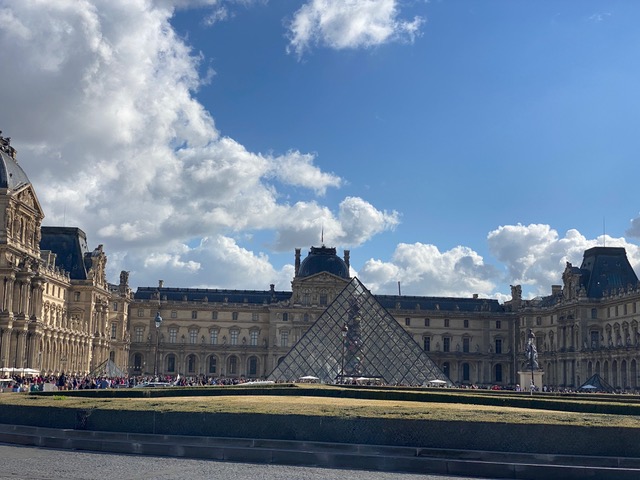 Pyramid looking building in front of old buildings