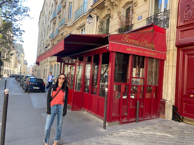 Girl standing outside red restaurant