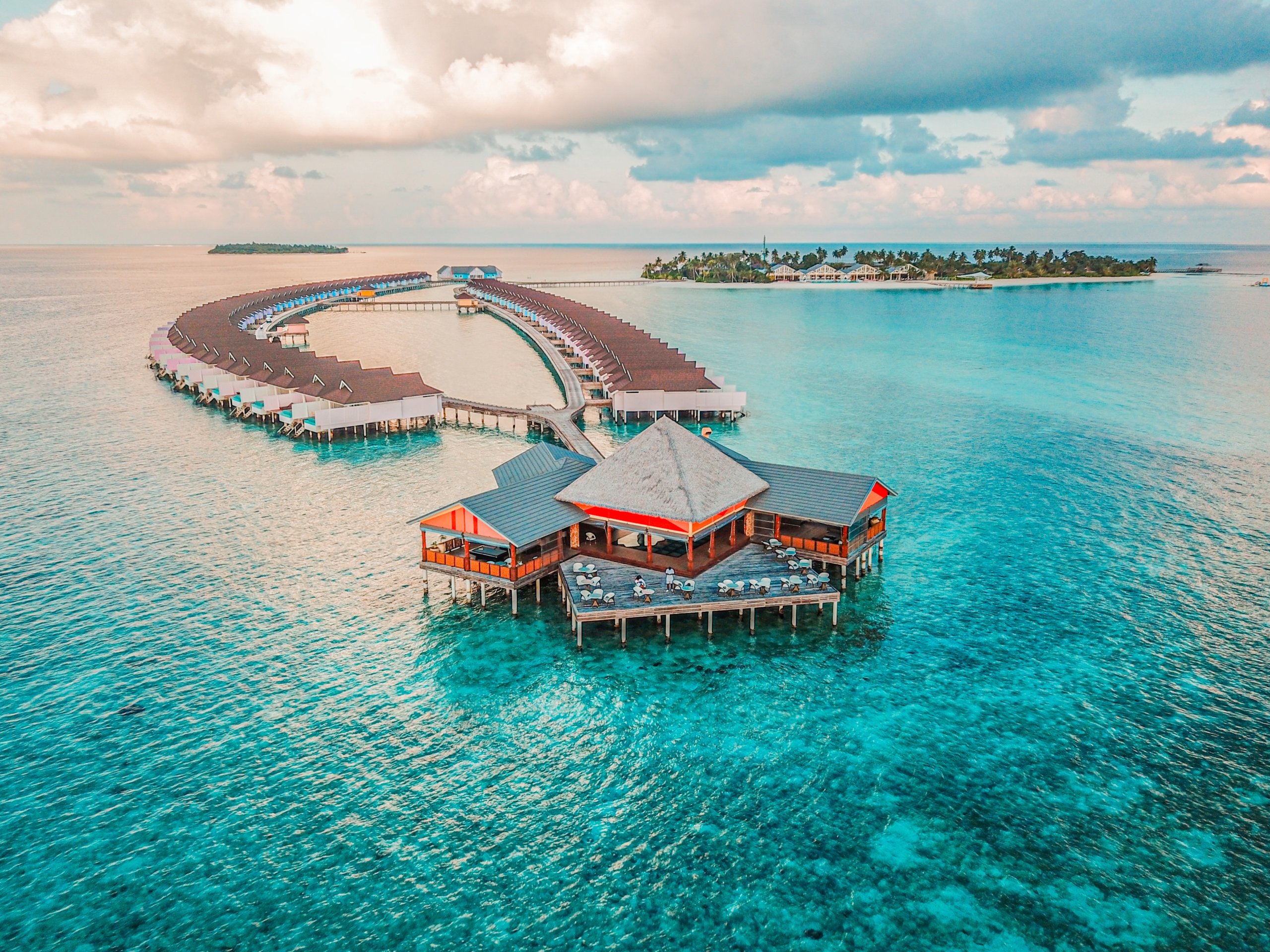 Overwater villas near white sand and turquoise water