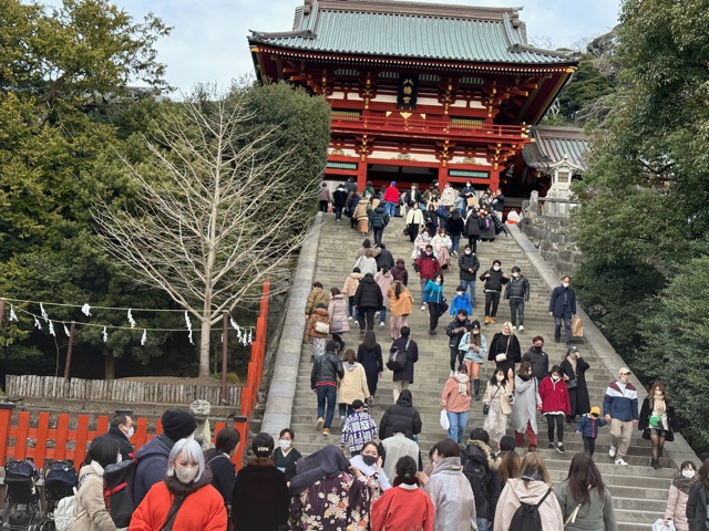 Red building with stairs in front of it.
