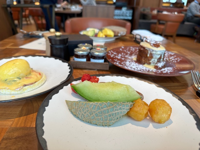 Breakfast foods on white plates.