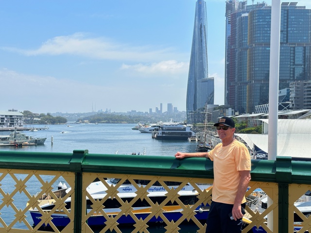 Man standing by wall near harbor