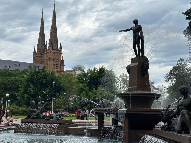 Statue in park with church