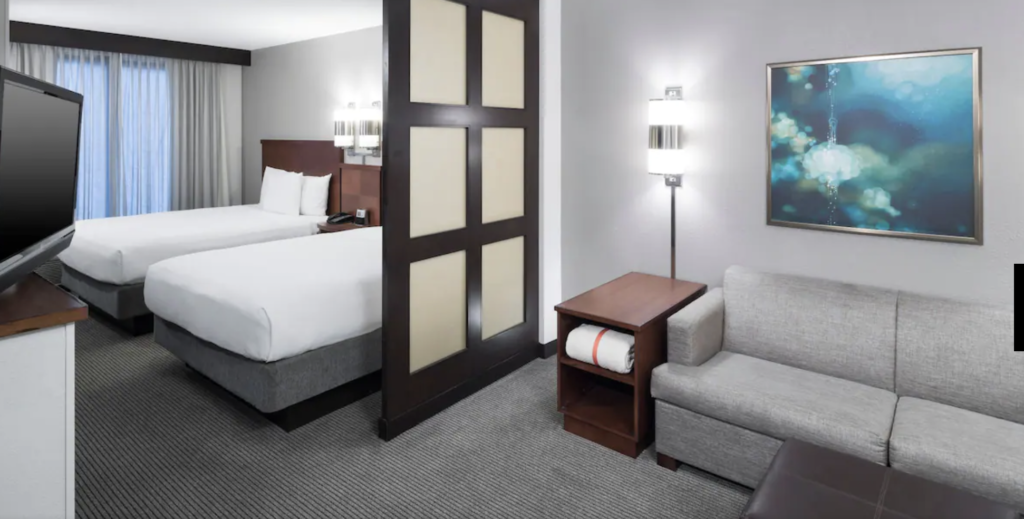 Hotel room with two queen beds and living area