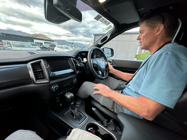Man in vehicle with driver's wheel on right side.
