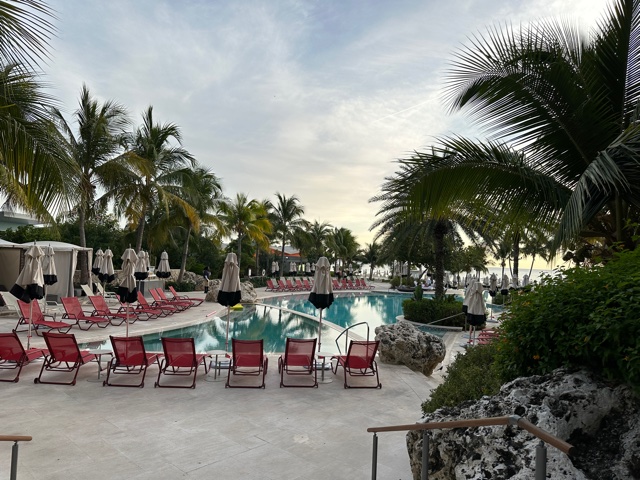 Pool area with pink lounge chairs