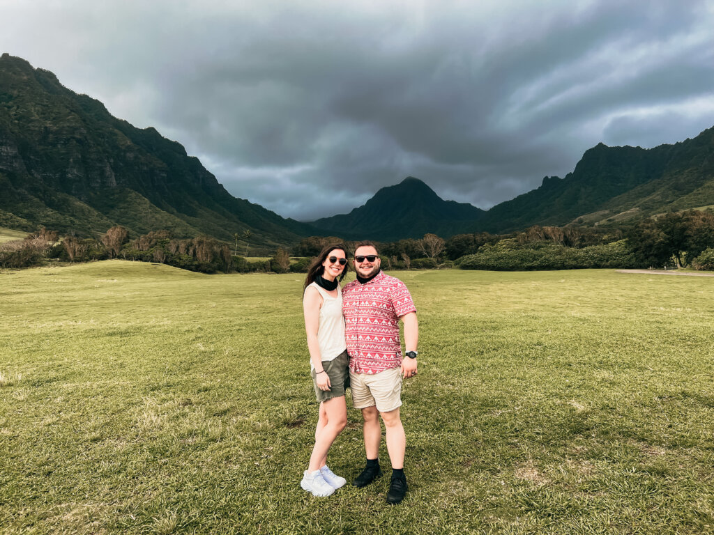 Man and woman standing in front of hills