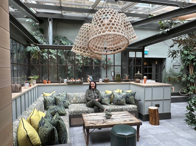 Seating area in a hotel with woman sitting on couch