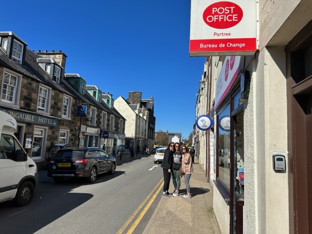 Two girls standing near post office
