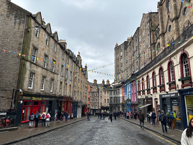 Stores lining both sides of street with colorful flags