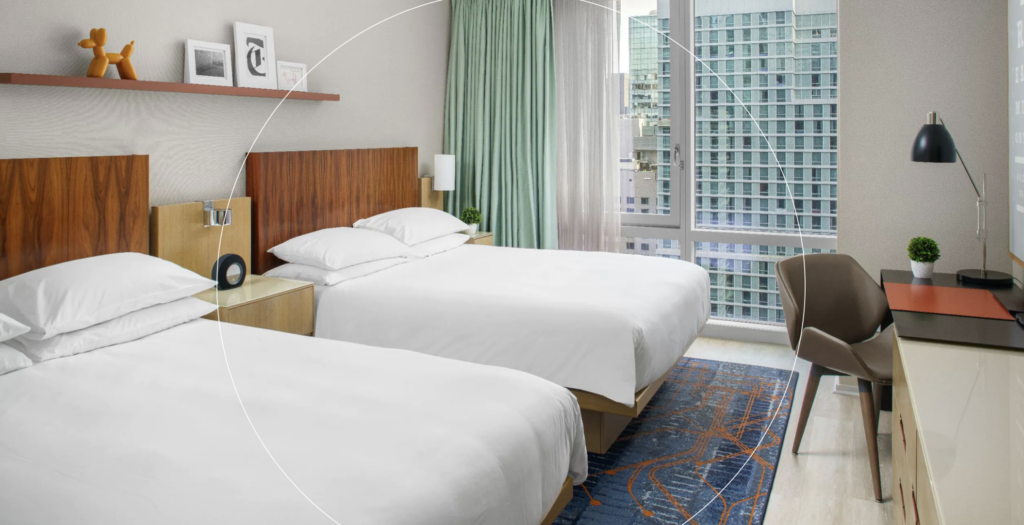Hotel room with 2 queen beds and white covers
