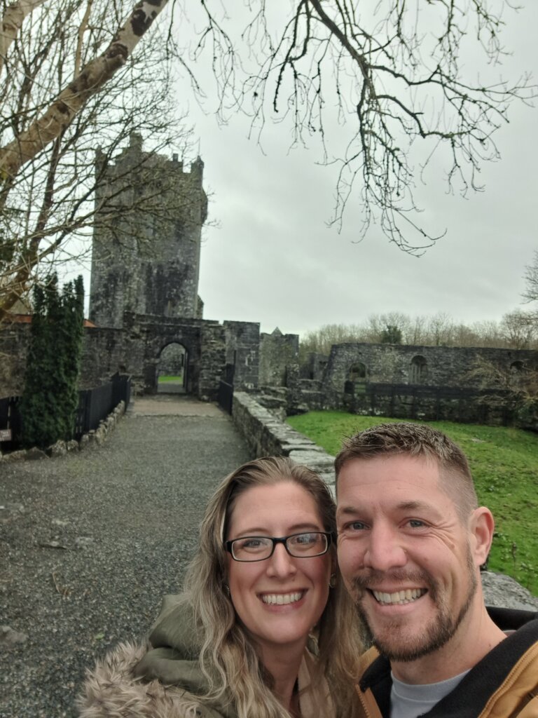 Man and woman standing near castle.