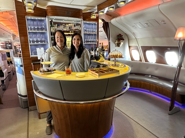 Two women behind a bar.