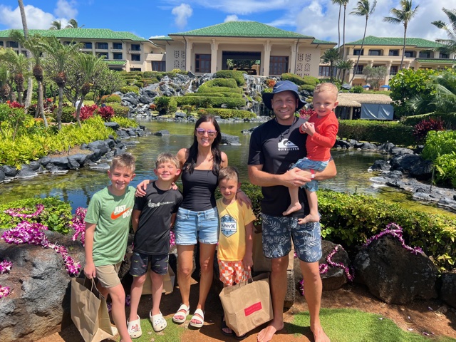 Family of 6 standing in front of hotel
