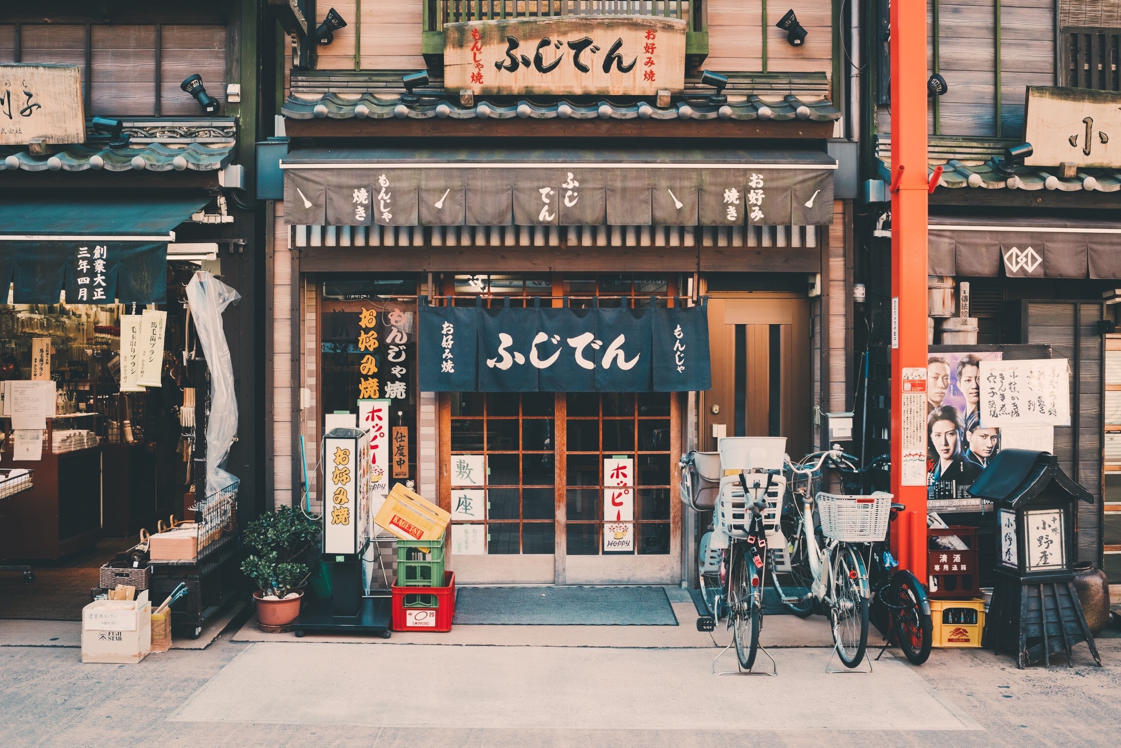 Bicycles parked outside building with Japanese signage
