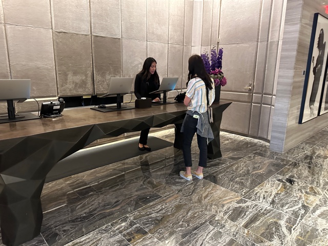 Girl standing in front of desk at hotel
